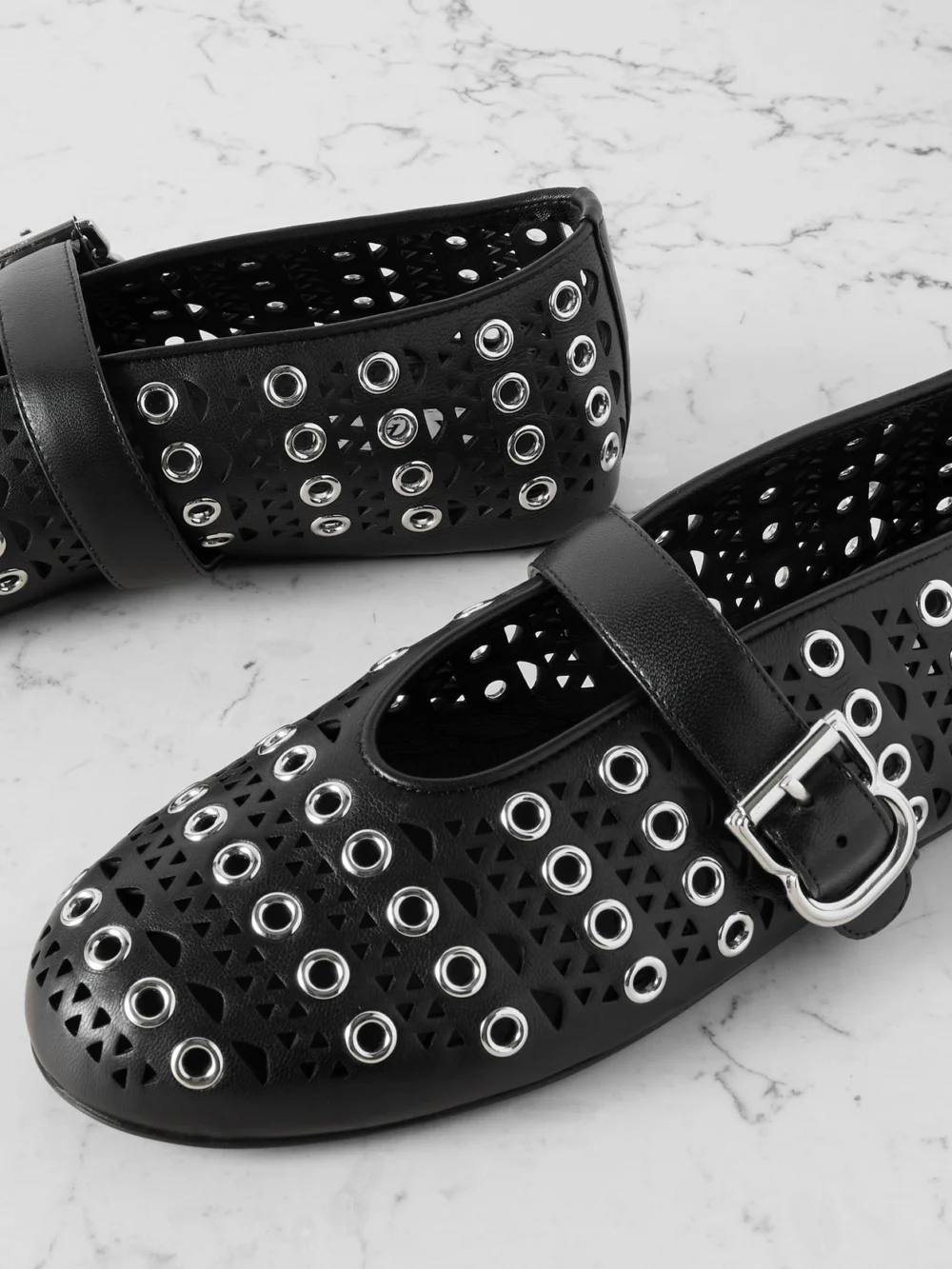 Close-up detail of the Alaïa Vienne Perforated Eyelet-embellished Leather Ballet Flats