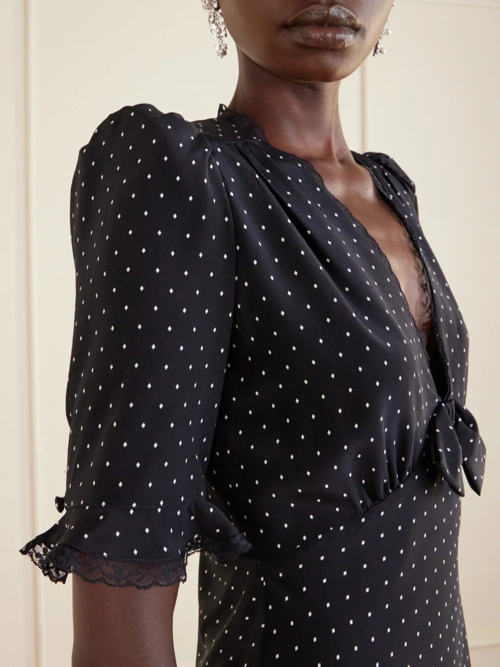 Close-up detail of the Alessandra Rich Bow-embellished Polka-dot Silk-satin Mini Dress
