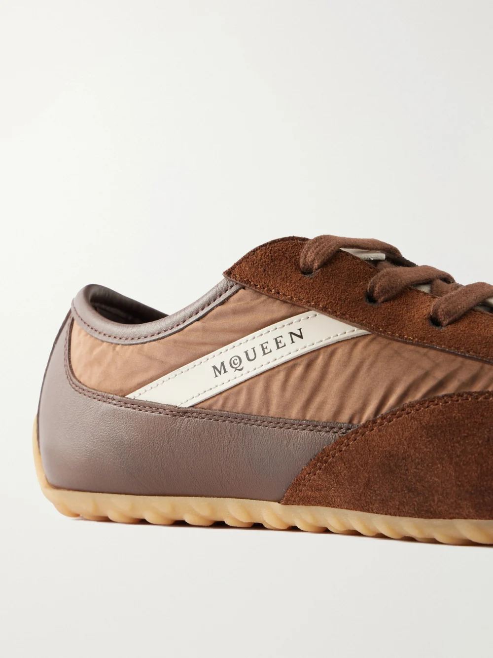 Close-up detail of the Alexander McQueen Boxe Leather-trimmed Suede Sneakers
