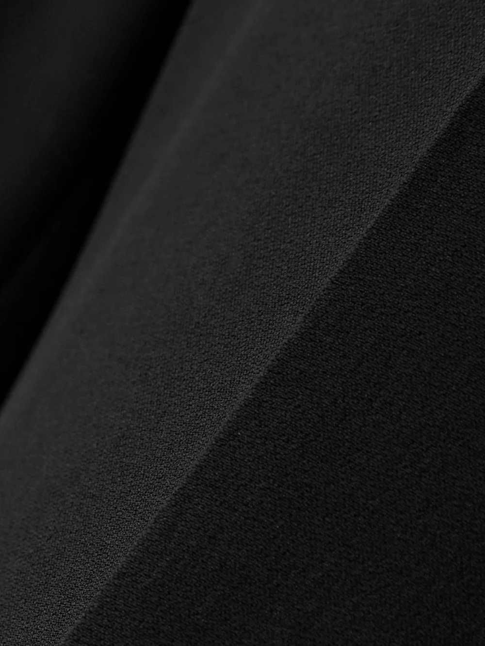 Close-up detail of the Alexander McQueen Crepe Bootcut Pants