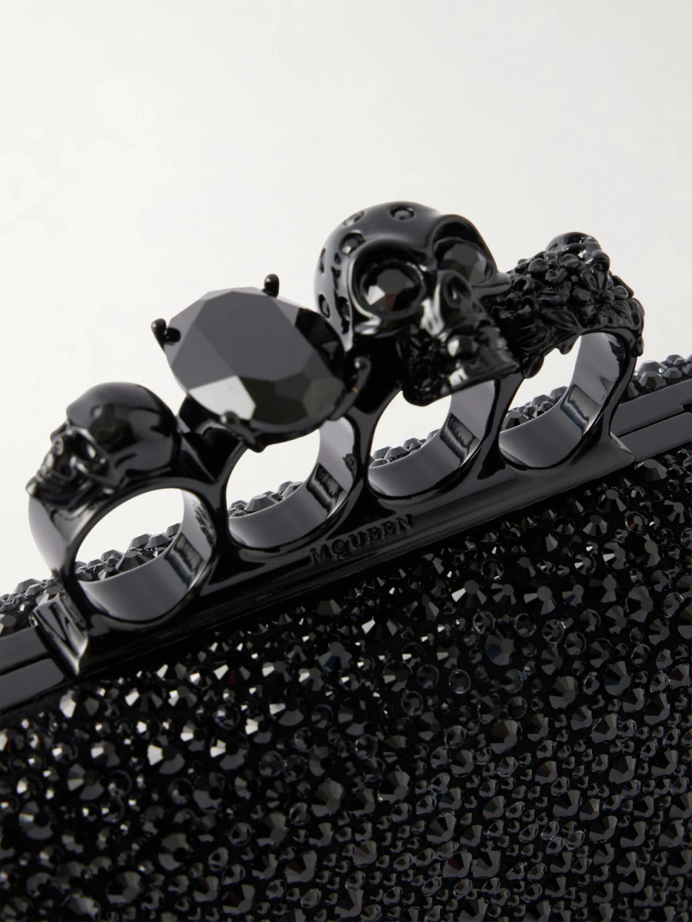 Close-up detail of the Alexander McQueen Knuckle Crystal-embellished Suede Clutch