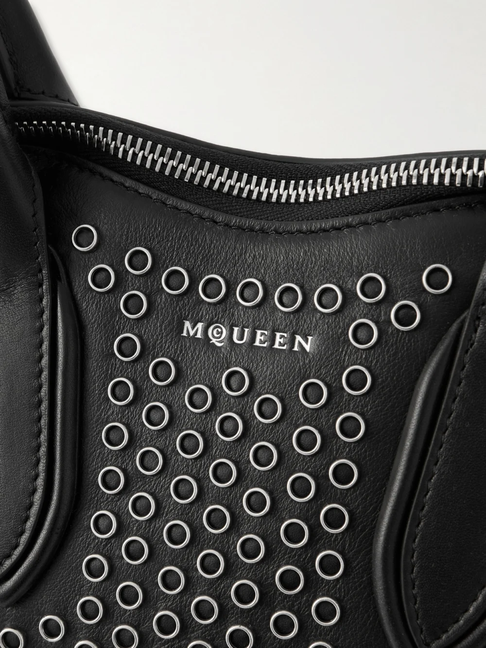 Close-up detail of the Alexander McQueen Manta Eyelet-embellished Leather Shoulder Bag