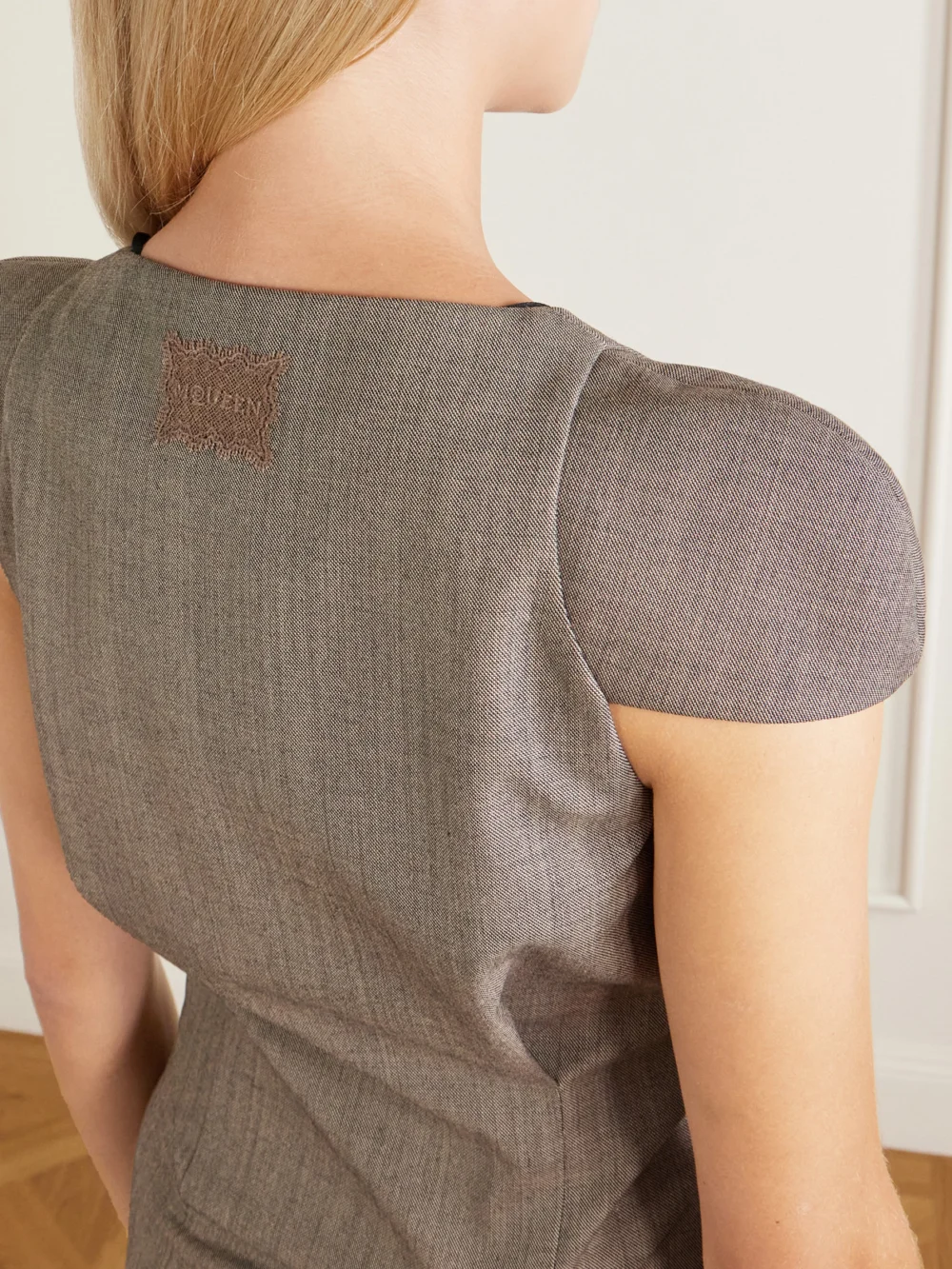 Close-up detail of the Alexander McQueen Pleated Wool-grisaille Mini Dress
