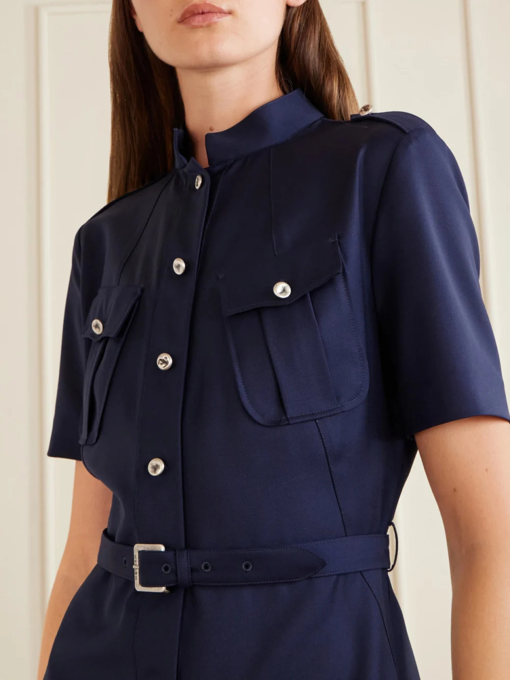 Close-up detail of the Alexander McQueen Police Belted Pleated Midi Dress