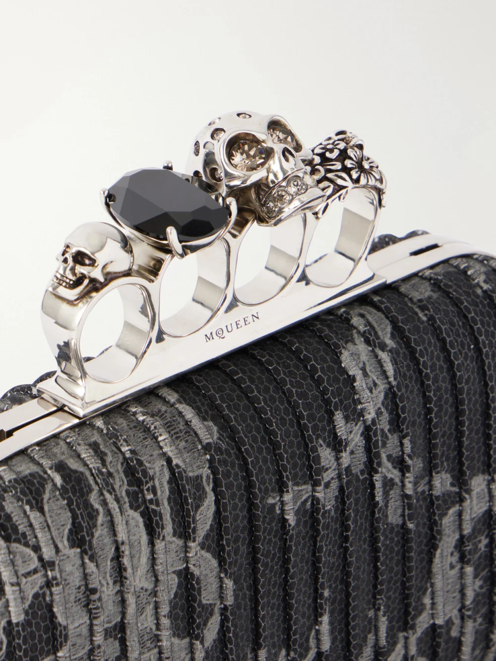 Close-up detail of the Alexander McQueen Skull Lace-trimmed Brocade Clutch