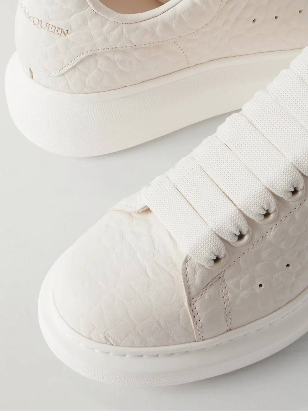 Close-up detail of the Alexander McQueen Textured-leather Exaggerated-sole Sneakers
