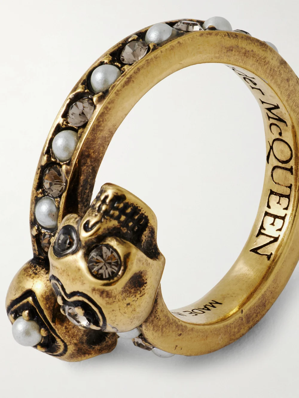 Close-up detail of the Alexander McQueen Wrapped Skull Gold-tone, Crystal and Faux Pearl Ring