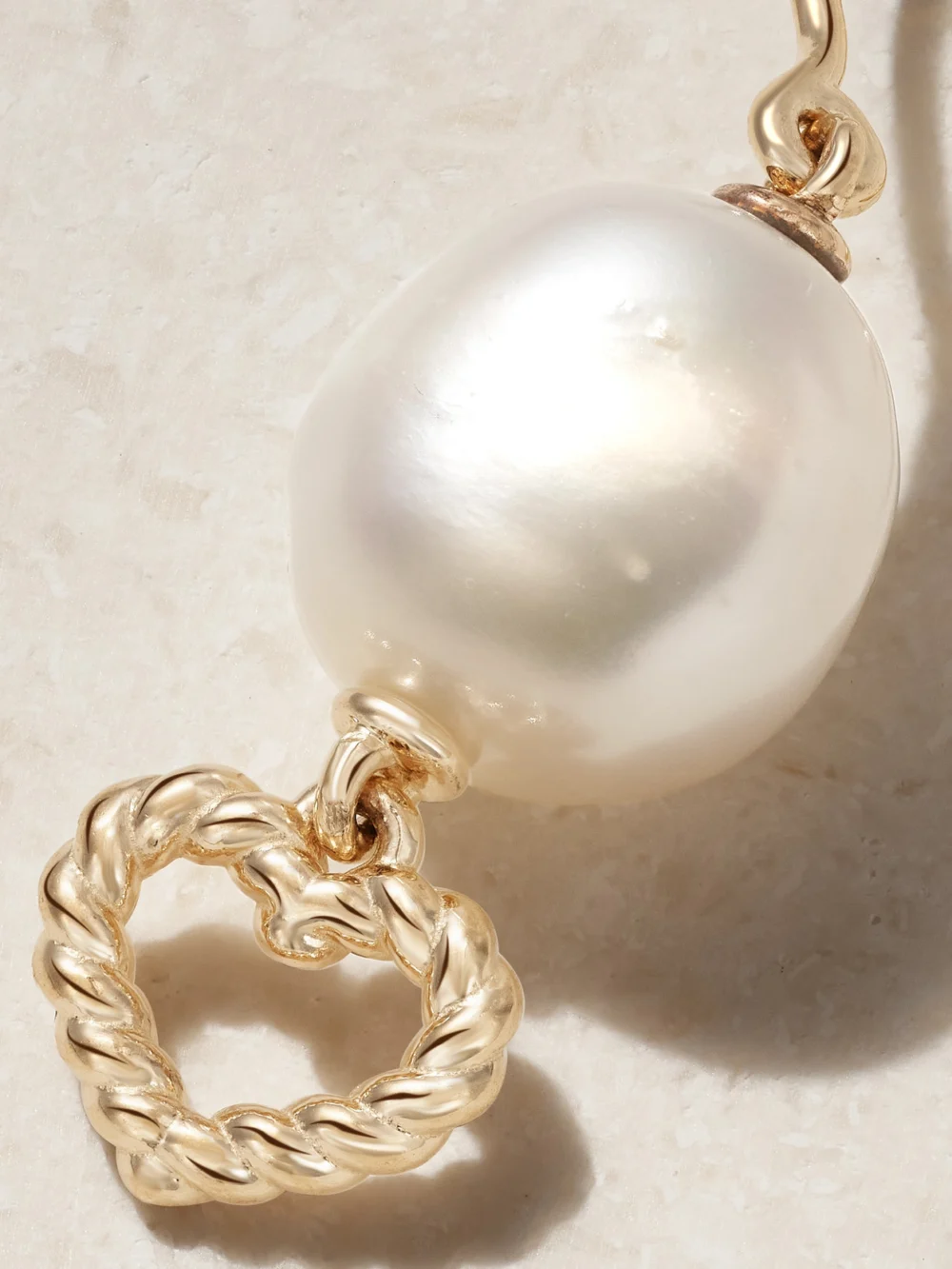 Close-up detail of the Alison Lou Heart Streamer 14-karat Gold Pearl Single Earring