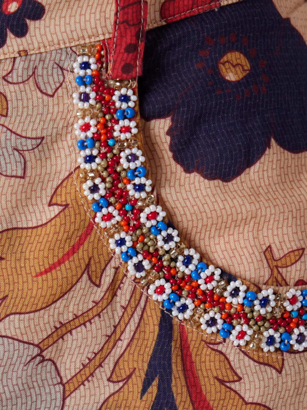 Close-up detail of the Alix Of Bohemia Bunny Bead-embellished Floral-print Cotton-voile Flared Pants