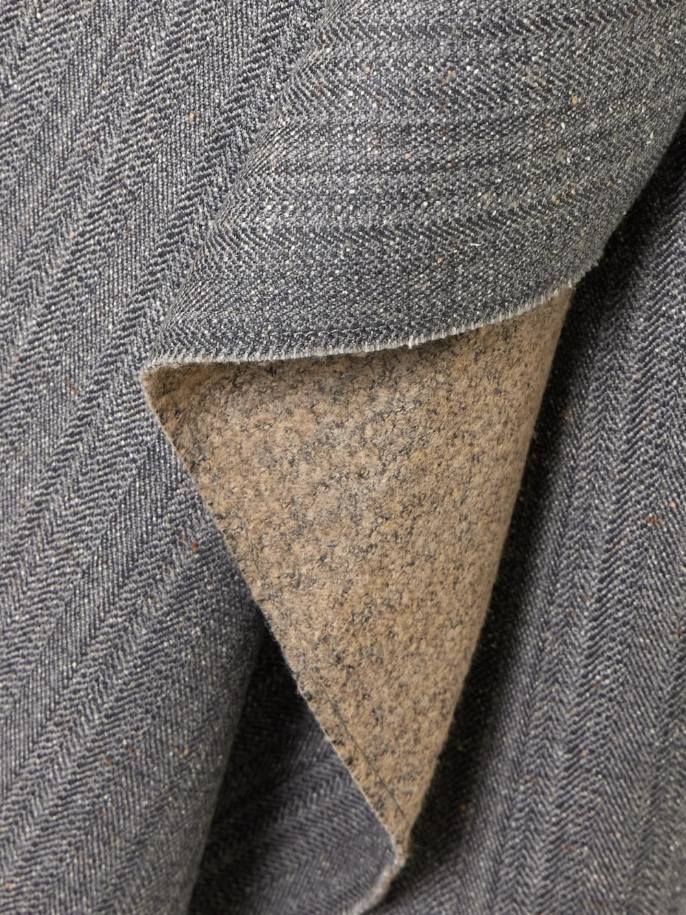 Close-up detail of the Ami Paris Distressed Herringbone Wool-blend Wrap Midi Skirt