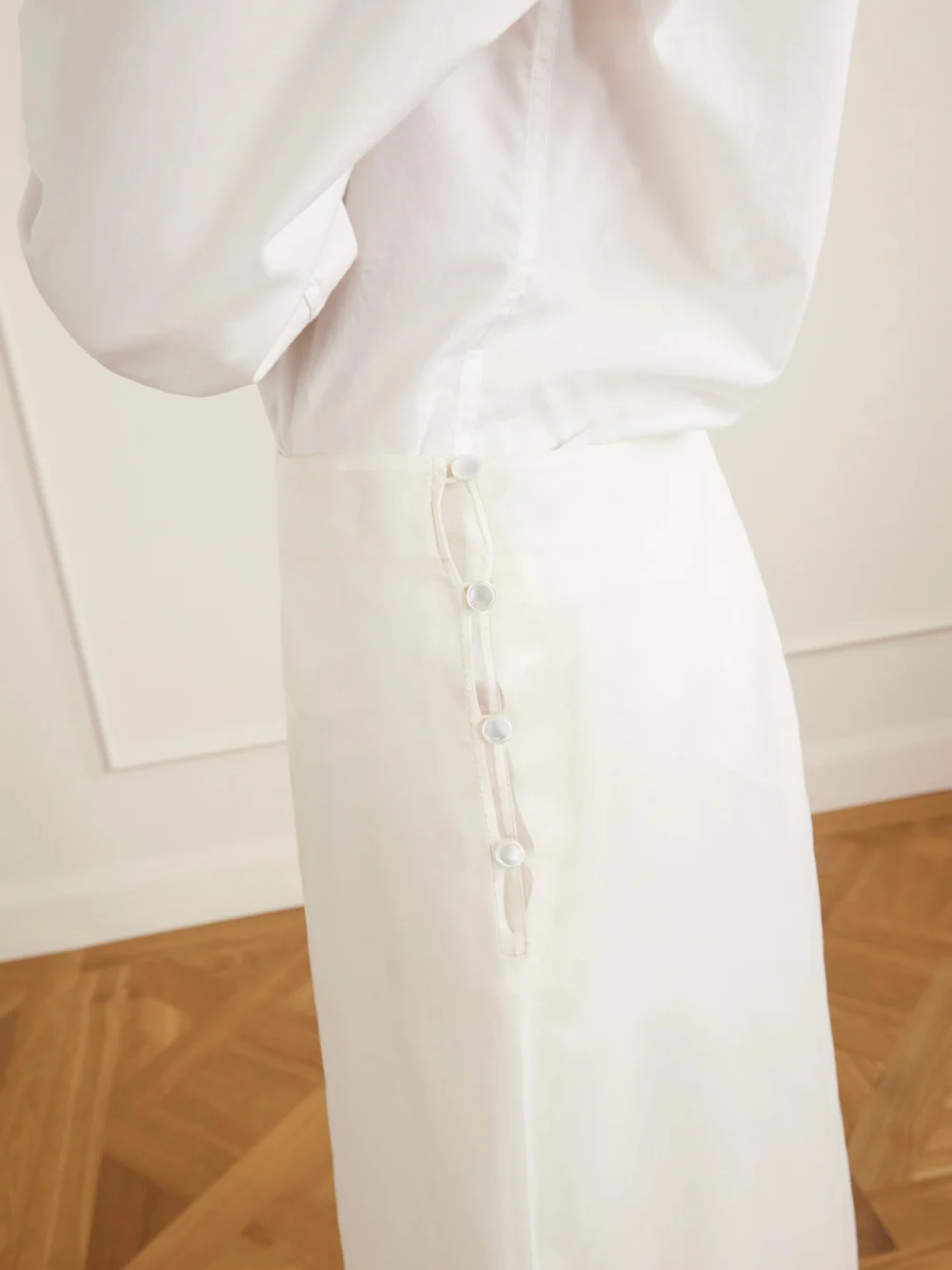 Close-up detail of the Ami Paris Sheer Silk Midi Skirt