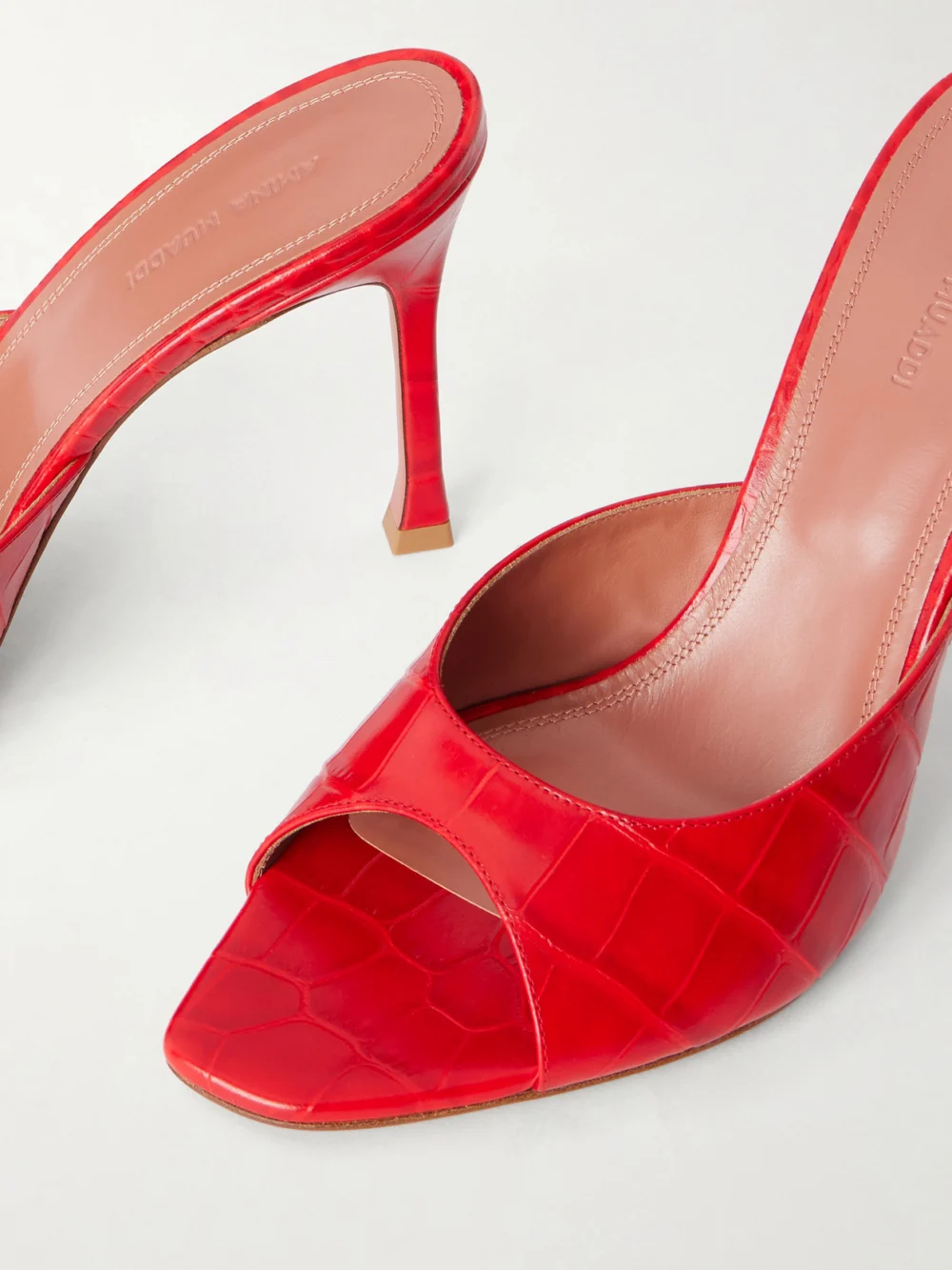 Close-up detail of the Amina Muaddi Alexa 95 Croc-effect Leather Mules
