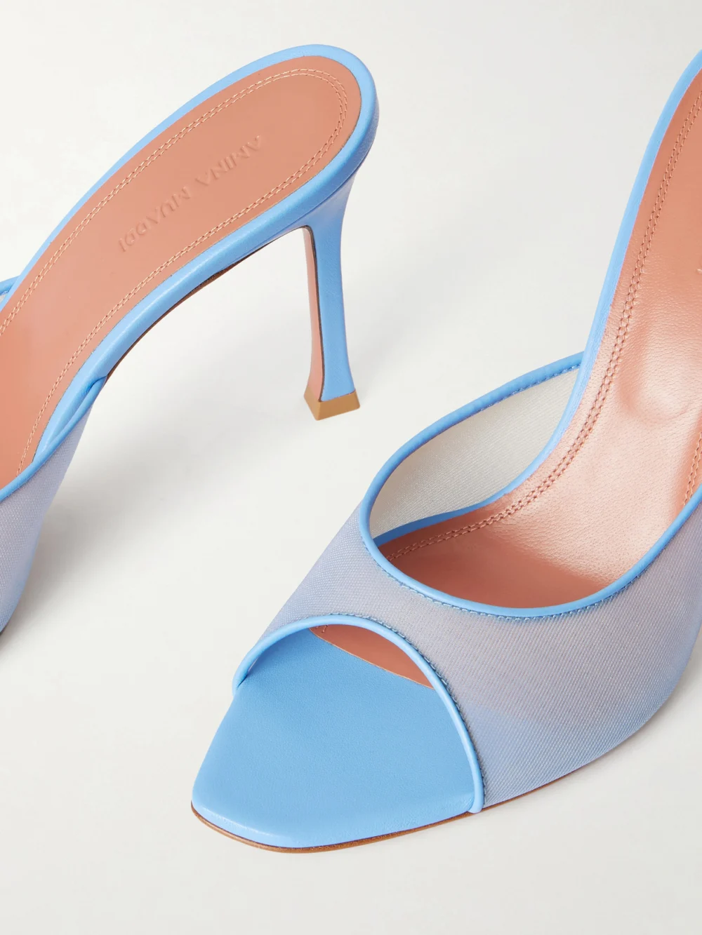 Close-up detail of the Amina Muaddi Alexa Leather-trimmed Mesh Mules