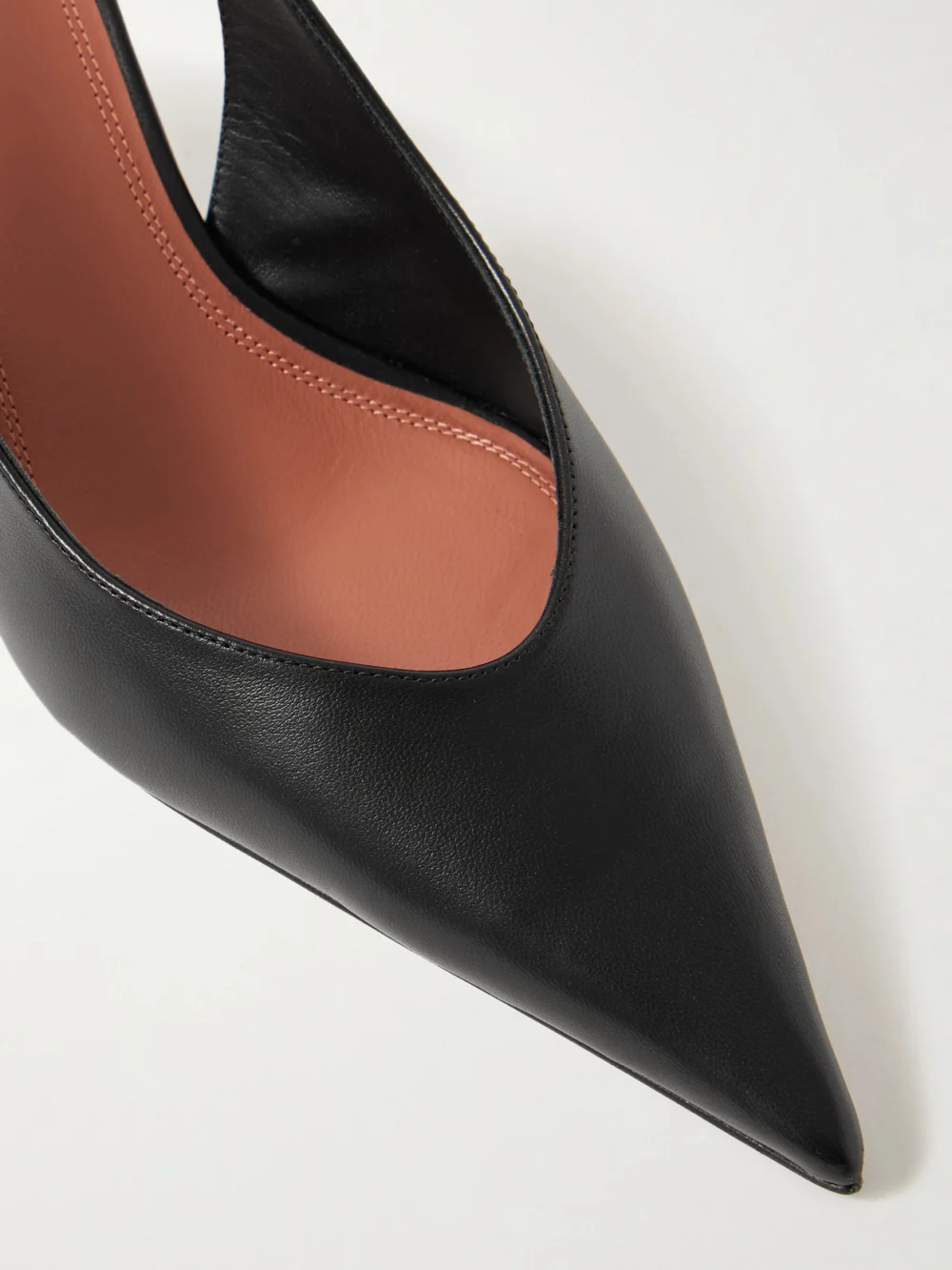 Close-up detail of the Amina Muaddi Anok Glossed-leather Slingback Pumps