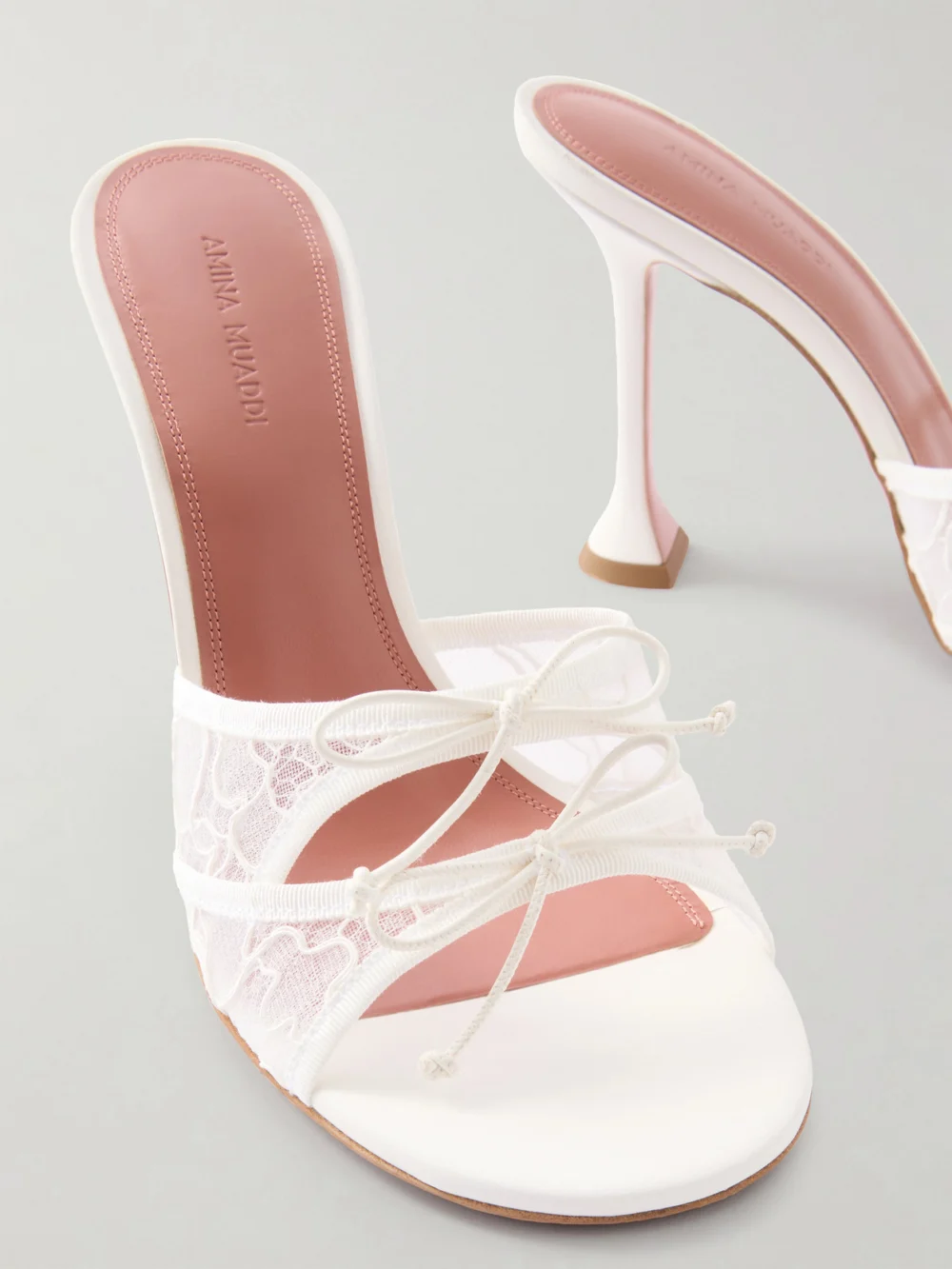 Close-up detail of the Amina Muaddi Eleonora Bow-detailed Lace and Leather Mules