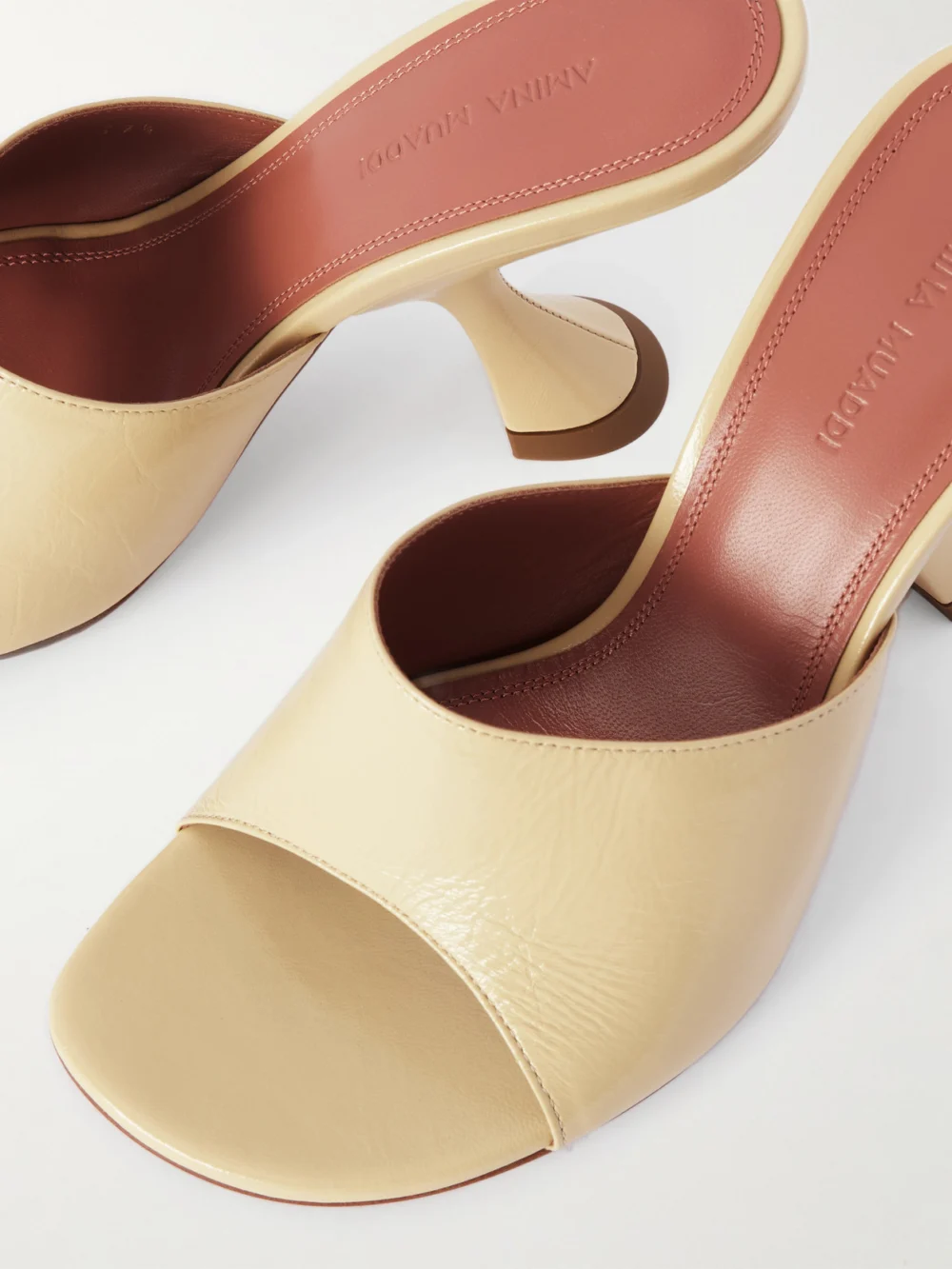Close-up detail of the Amina Muaddi Taylor Patent-leather Mules