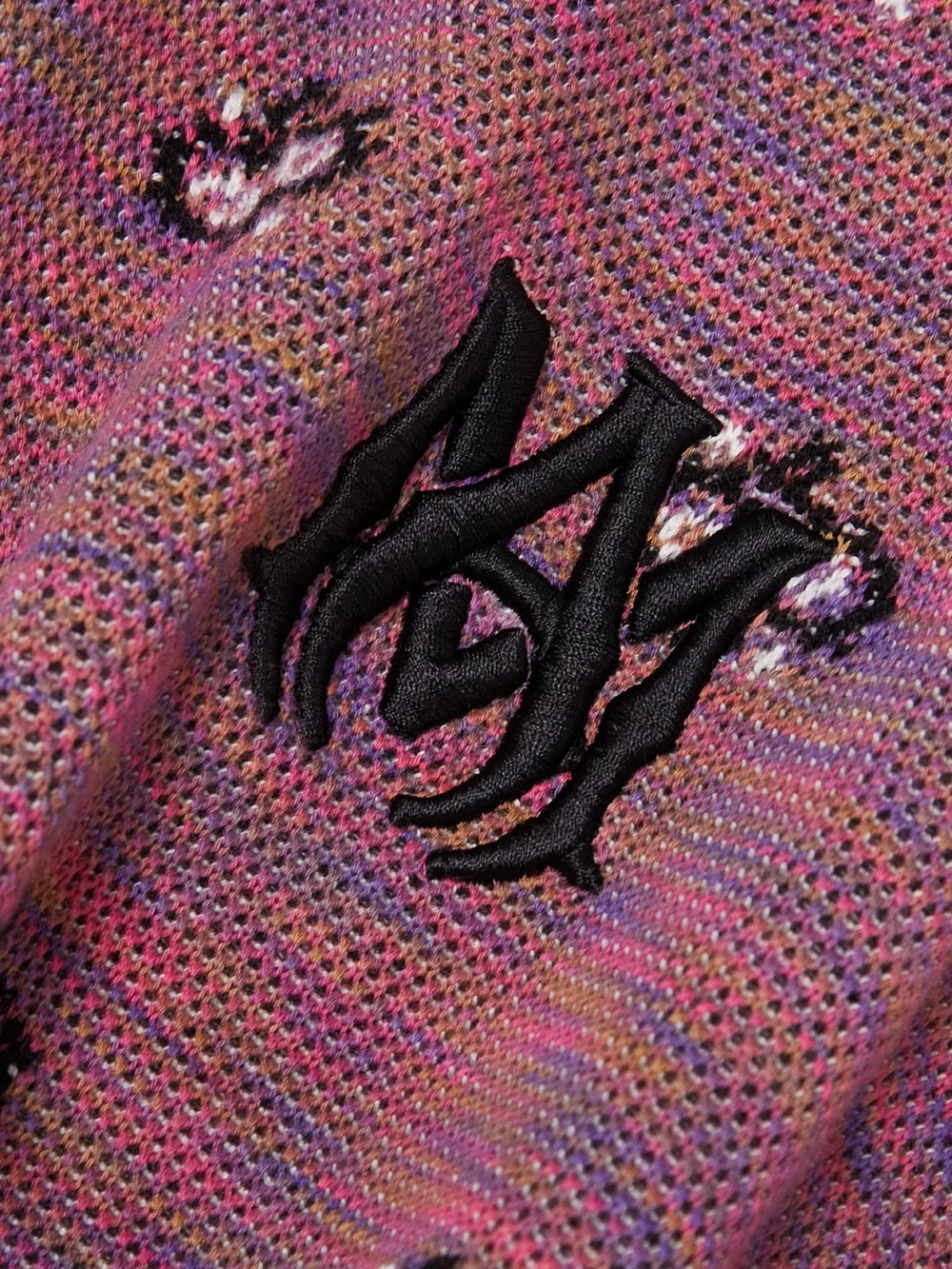 Close-up detail of the Amiri Cropped Embroidered Space-dyed Cotton-jacquard Hoodie