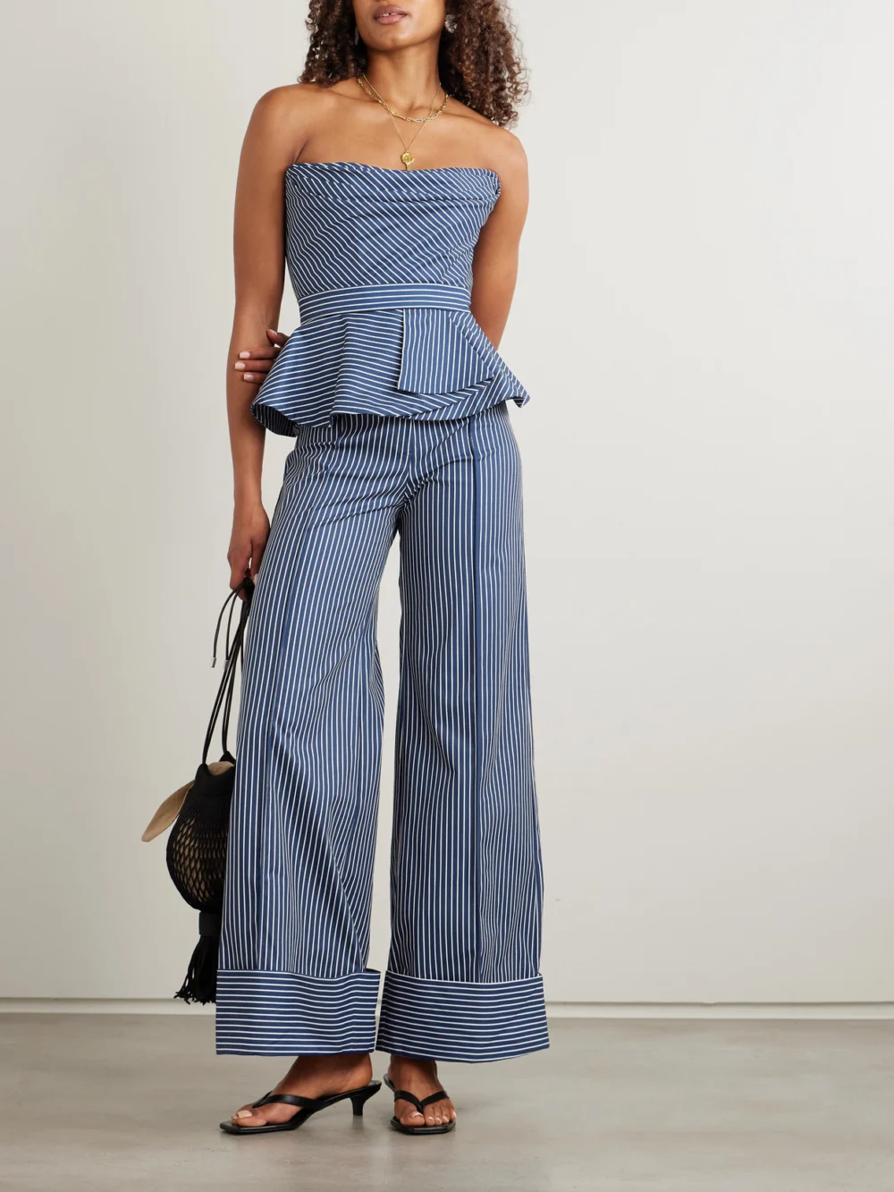 Andres Otalora Alborada Strapless Striped Stretch Cotton-twill Peplum Top, worn by a model