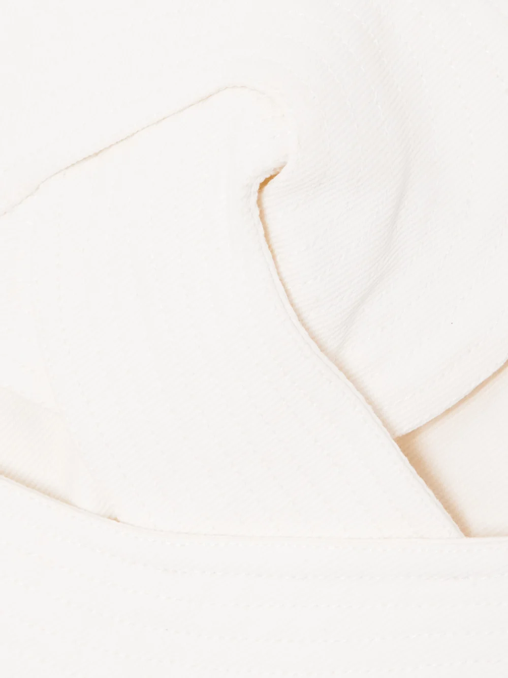 Close-up detail of the Andres Otalora Onda Strapless Cropped Twisted Cotton-twill Top