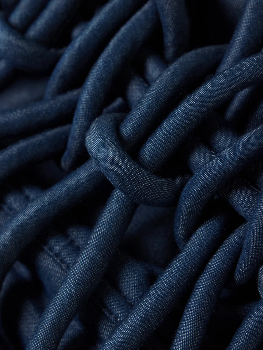 Close-up detail of the Andres Otalora Redes Cropped Corded Chambray Top