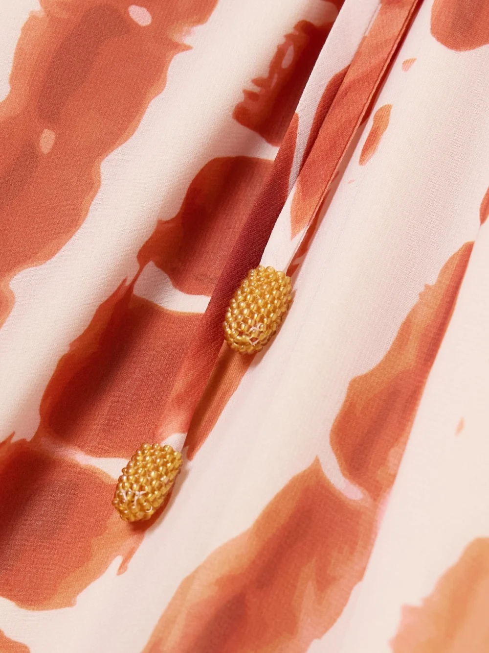 Close-up detail of the Andres Otalora Tha Embellished Tiered Printed Recycled-chiffon Maxi Dress