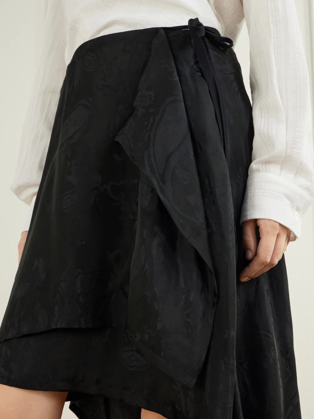 Close-up detail of the Ann Demeulemeester Birit Paisley-jacquard Satin Asymmetric Wrap Midi Skirt