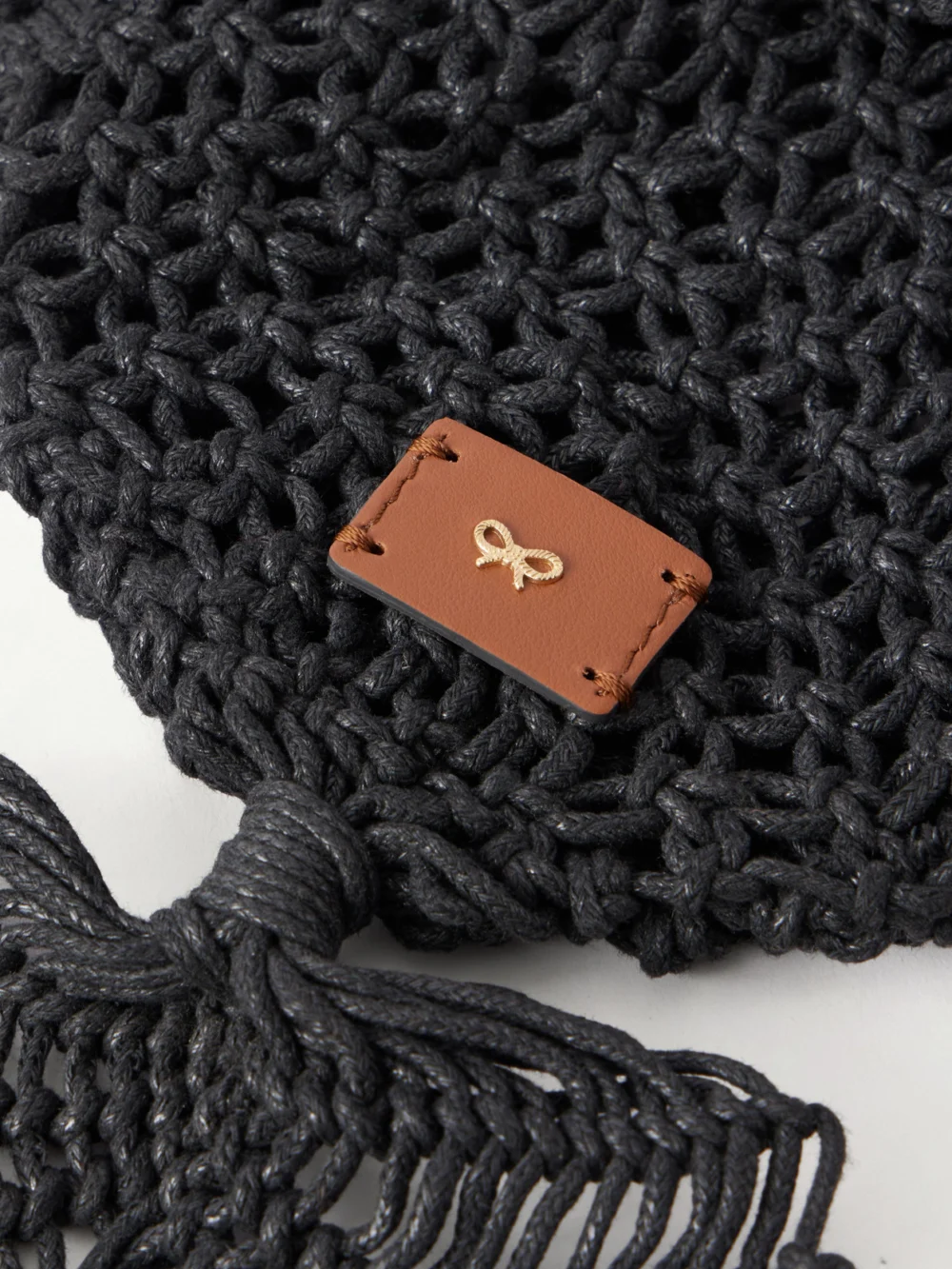 Close-up detail of the Anya Hindmarch Macrame Leather-trimmed Cotton Clutch