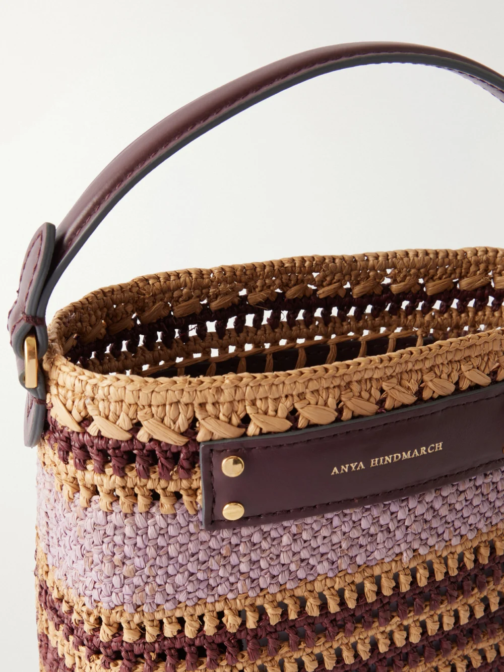 Close-up detail of the Anya Hindmarch Striped Raffia Cross Body Bag