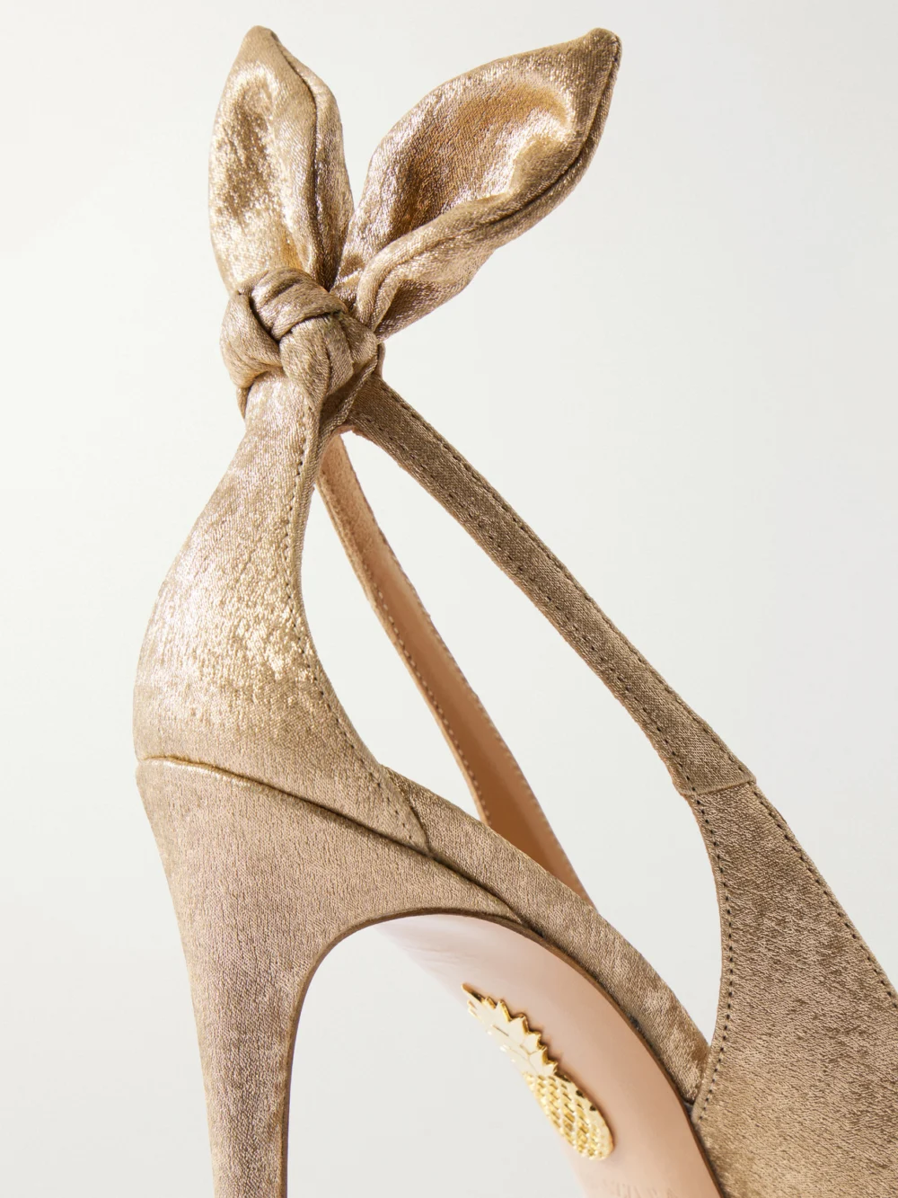 Close-up detail of the Aquazzura Bow Tie 105 Satin and Leather Pumps