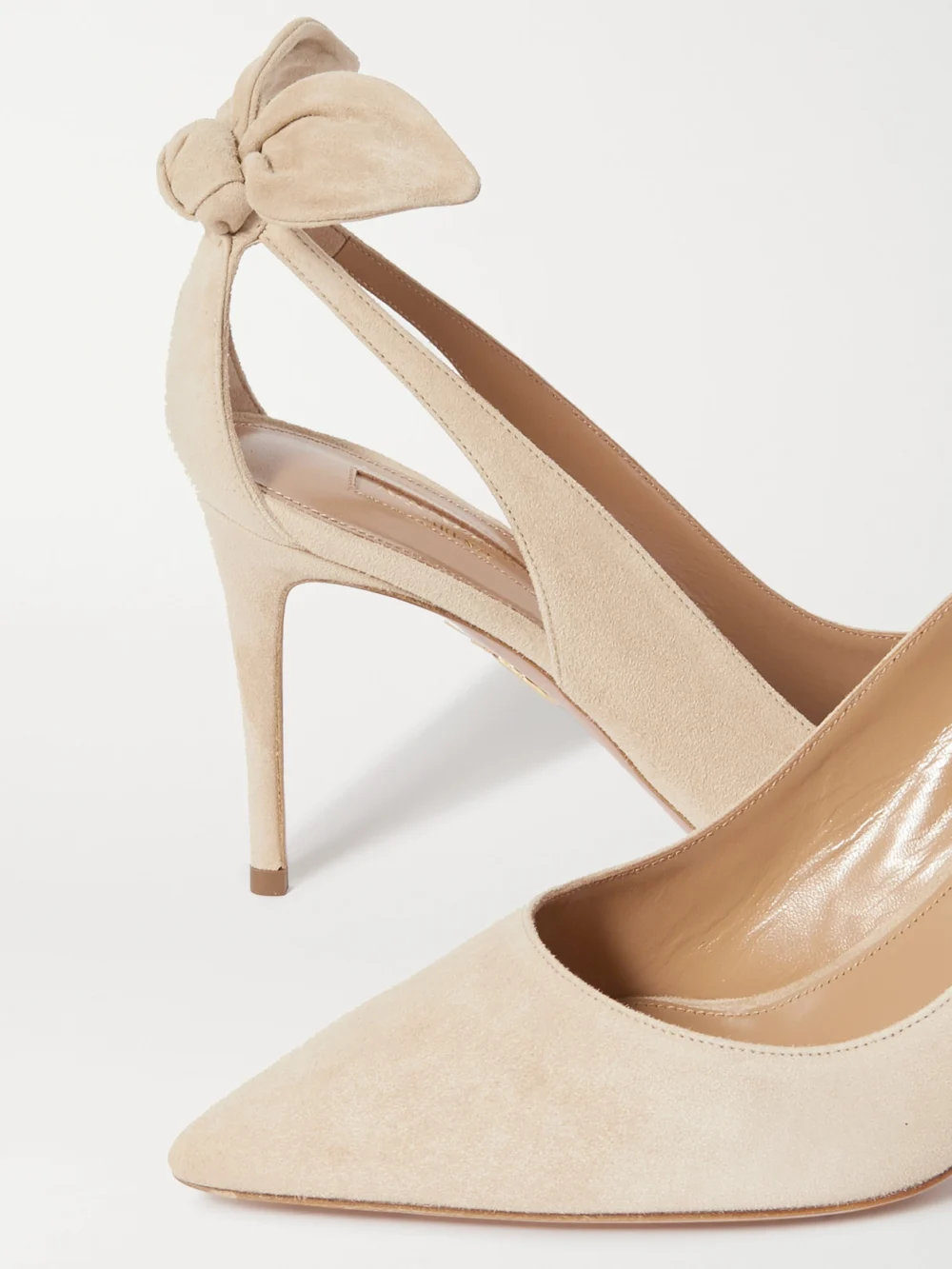 Close-up detail of the Aquazzura Bow Tie 85 Suede Pumps