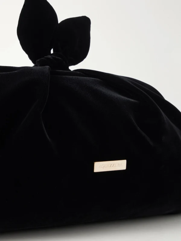 Close-up detail of the Aquazzura Bow Tie Velvet Clutch