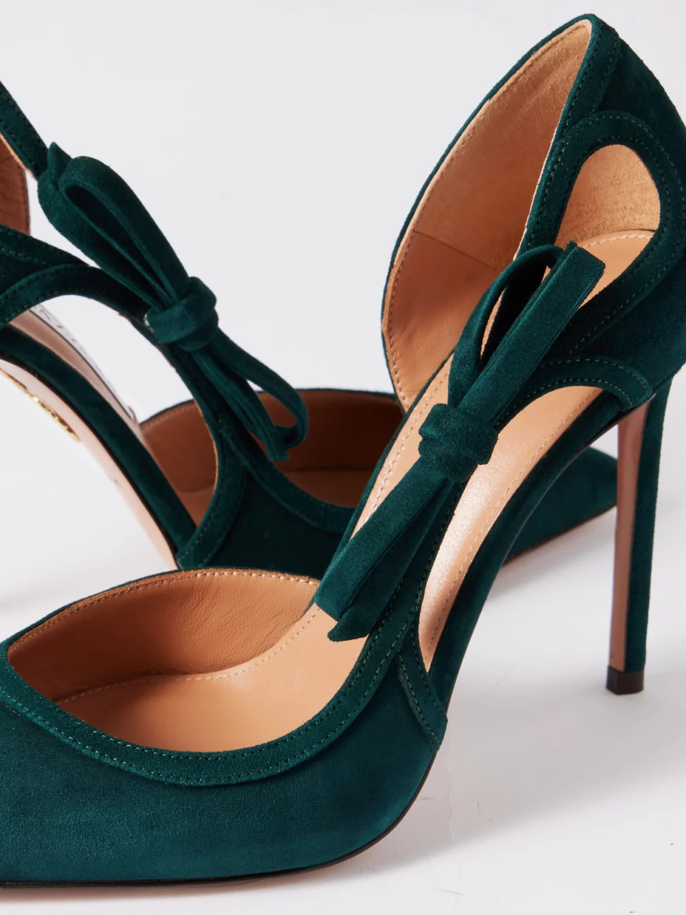 Close-up detail of the Aquazzura Soave 105 Bow-detailed Cutout Suede Pumps
