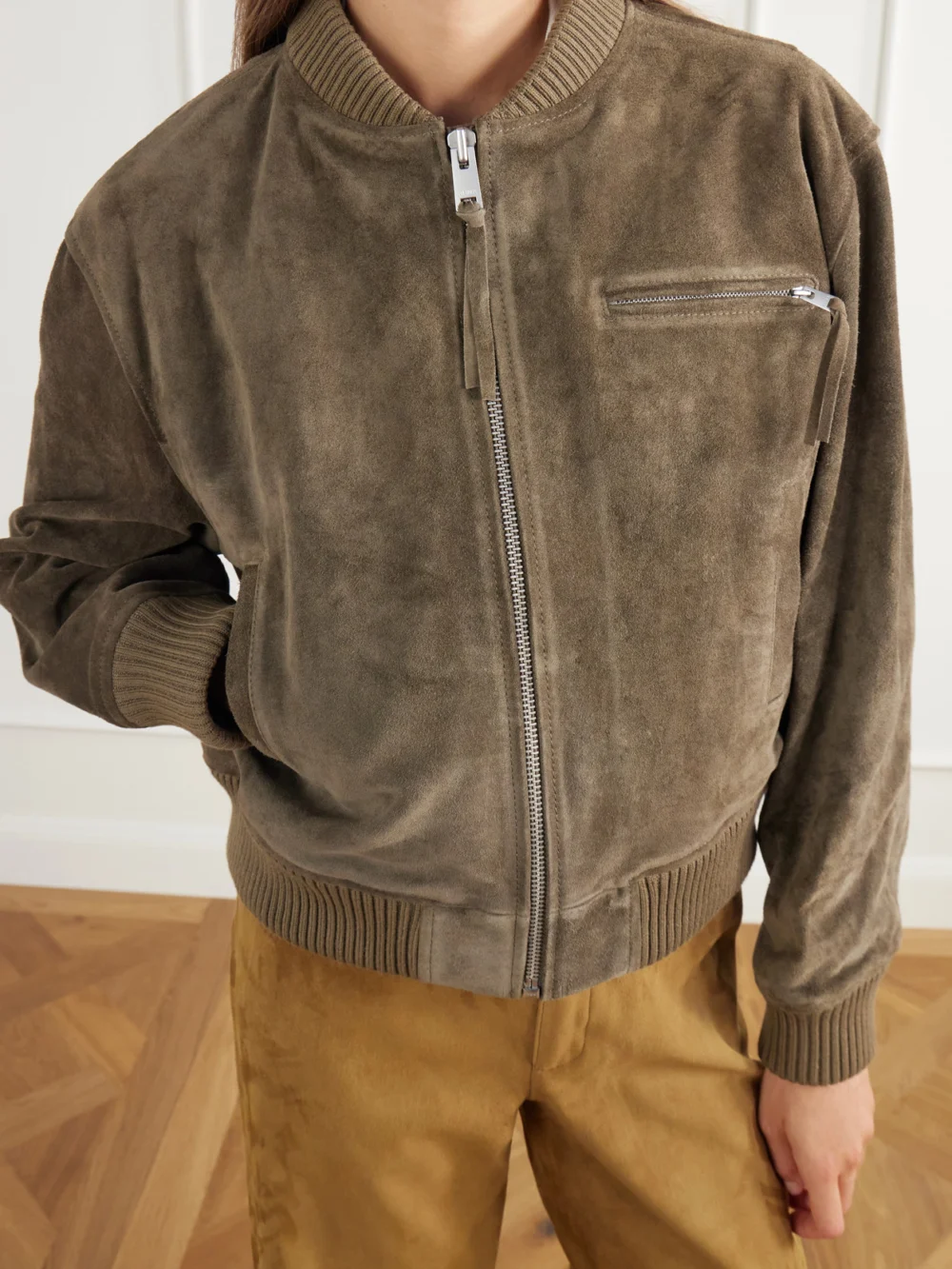 Close-up detail of the Arma Elysia Rib-trimmed Suede Bomber Jacket