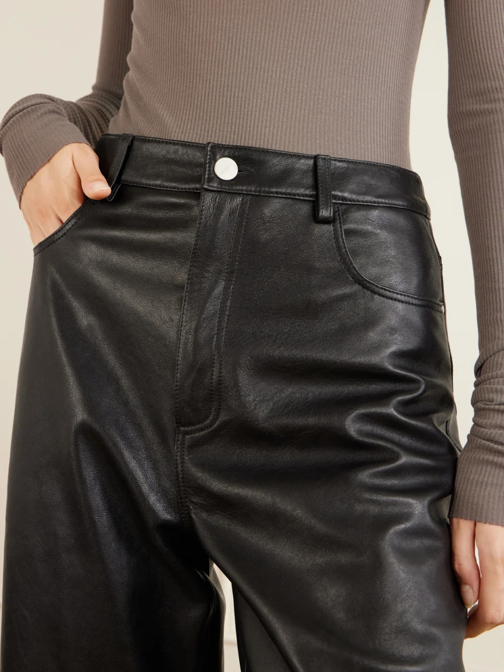 Close-up detail of the Arma Leather Wide-leg Pants