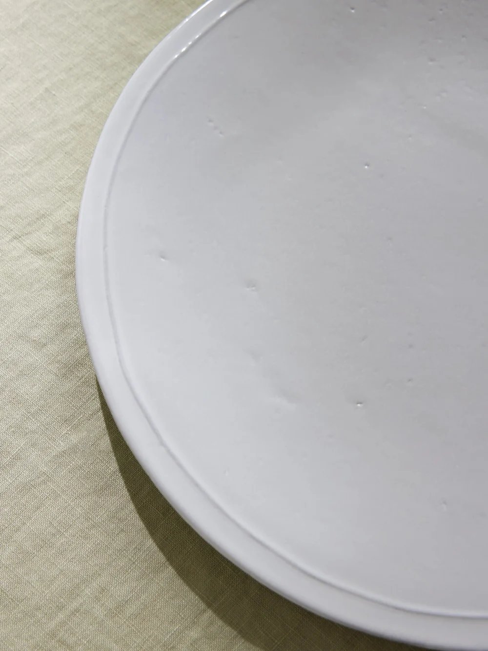 Close-up detail of the Astier De Villatte Simple Ceramic Dinner Plate