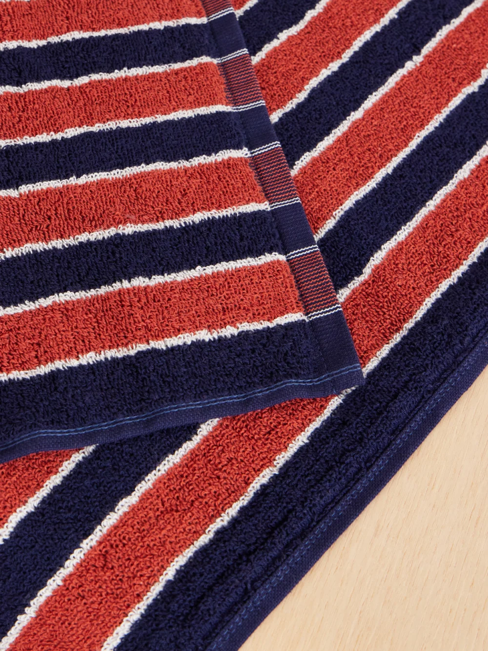 Close-up detail of the Autumn Sonata Helena Striped Organic Cotton-terry Beach Towel