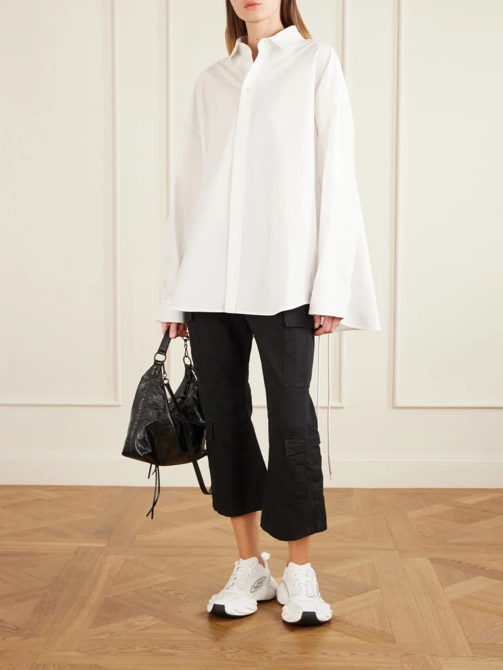 Balenciaga Cropped Paneled Cotton-ripstop Flared Cargo Pants, worn by a model