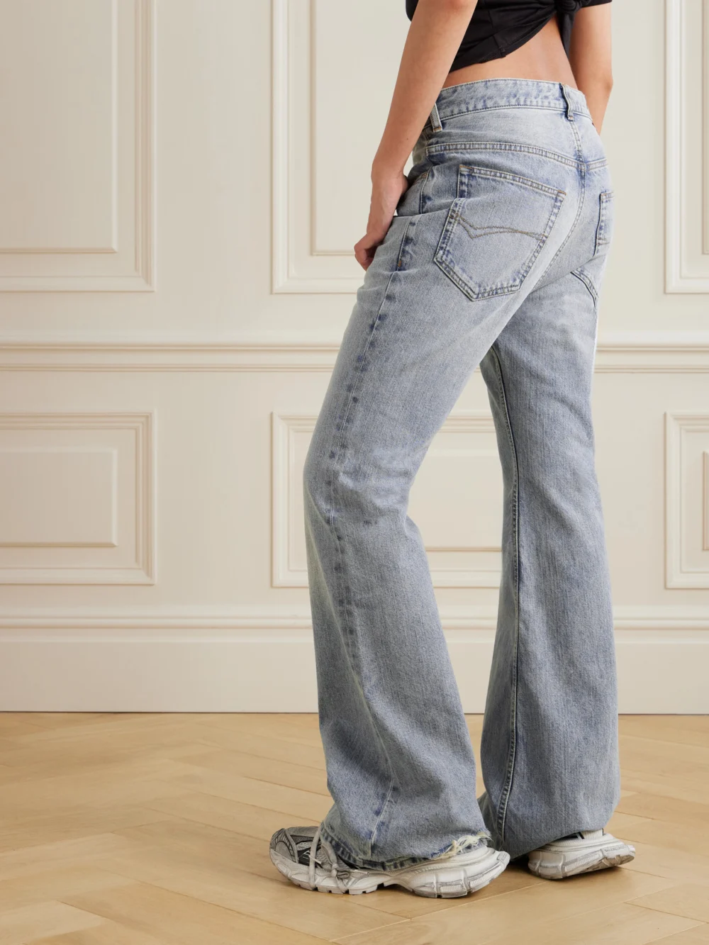 Back view of the Balenciaga Distressed Low-rise Flared Jeans