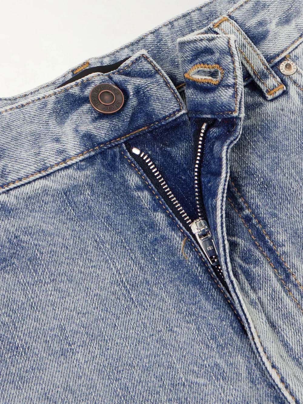 Close-up detail of the Balenciaga Distressed Low-rise Flared Jeans