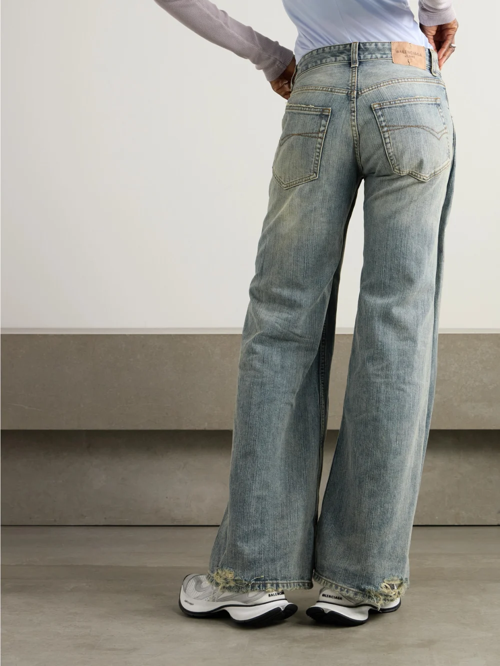 Back view of the Balenciaga Distressed Mid-rise Wide-leg Jeans