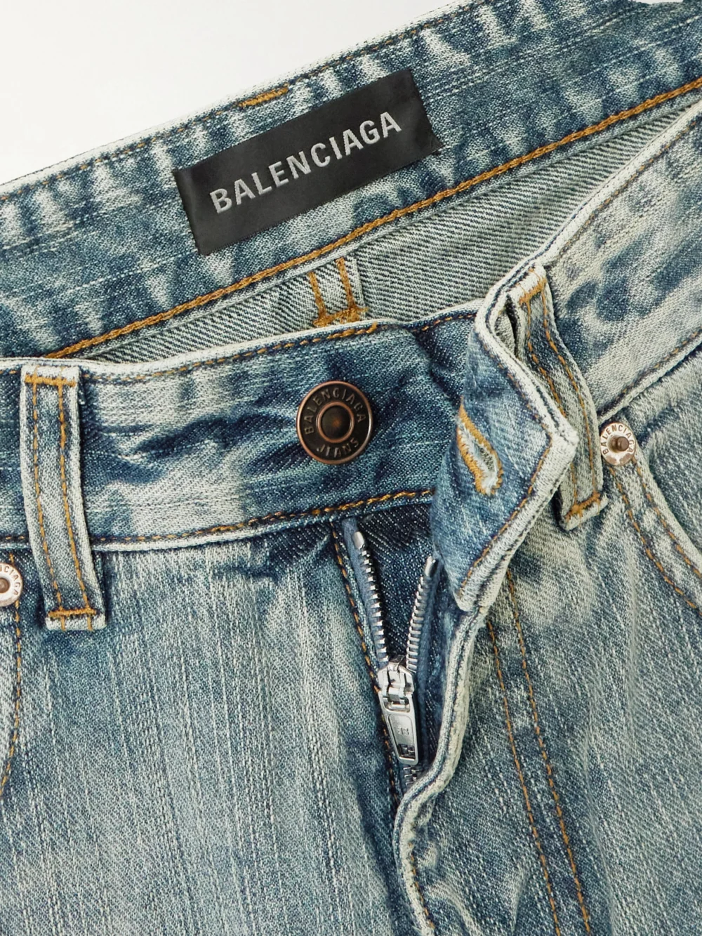 Close-up detail of the Balenciaga Distressed Mid-rise Wide-leg Jeans