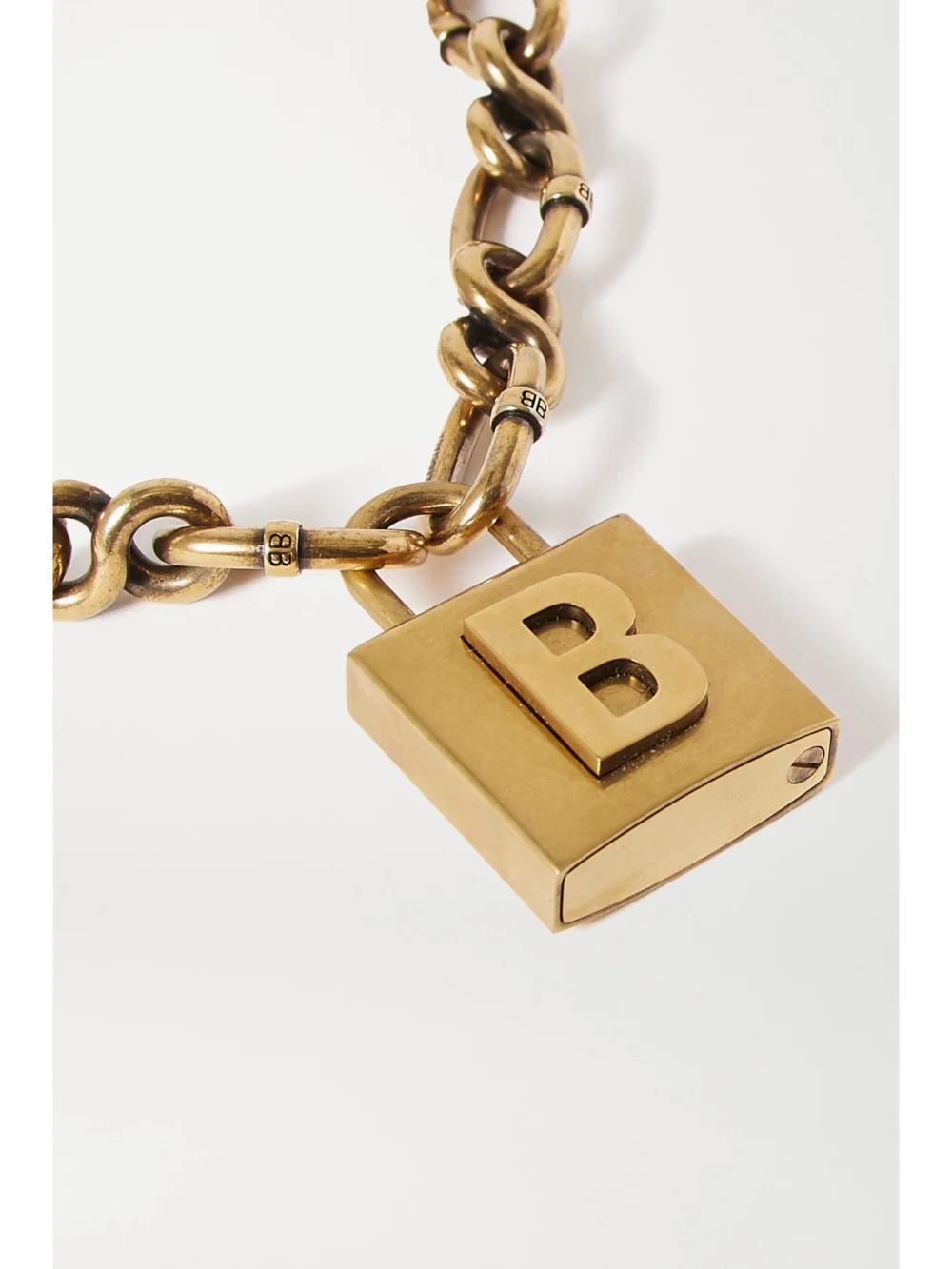 Close-up detail of the Balenciaga Lock Embossed Gold-tone Necklace