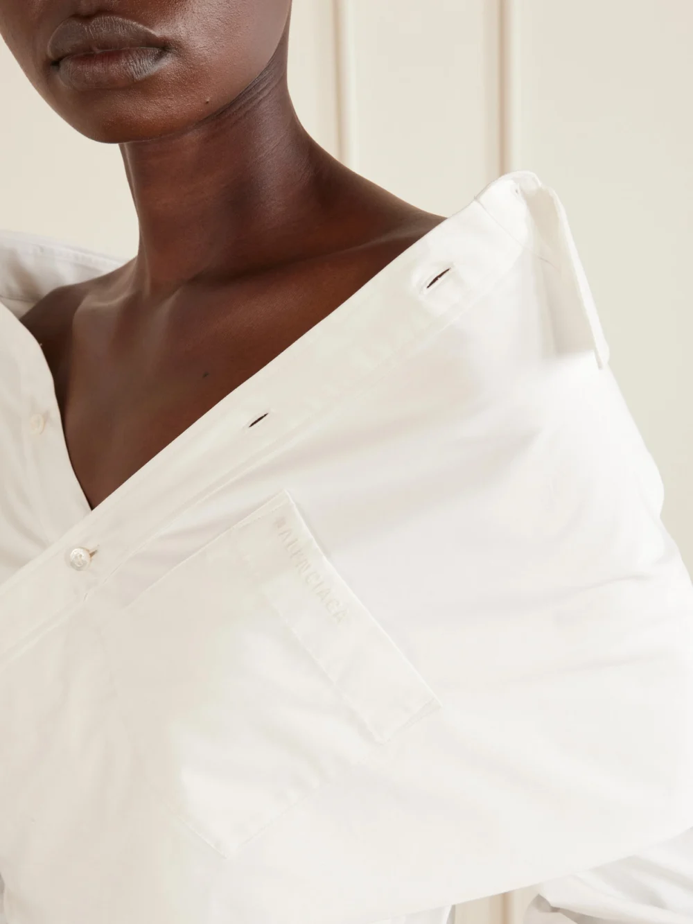Close-up detail of the Balenciaga Off-the-shoulder Cotton Poplin Blouse