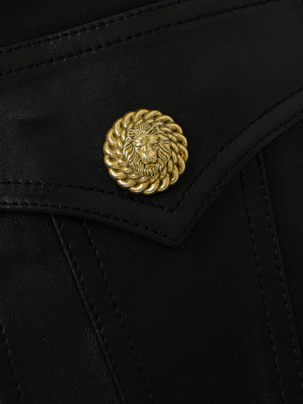 Close-up detail of the Balmain Belted Embellished Leather Mini Skirt