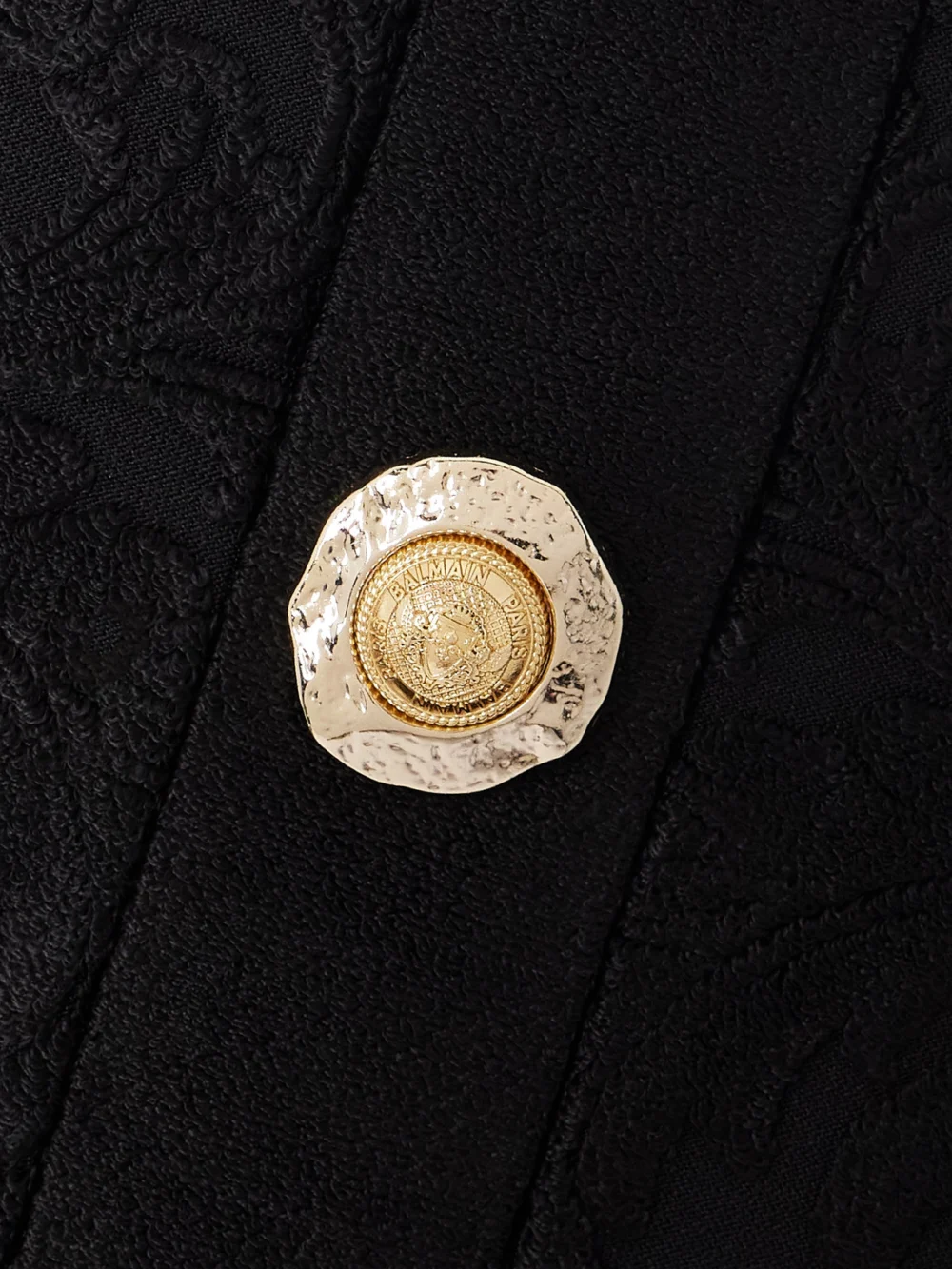 Close-up detail of the Balmain Button-embellished Bouclé Jacquard-knit Mini Dress
