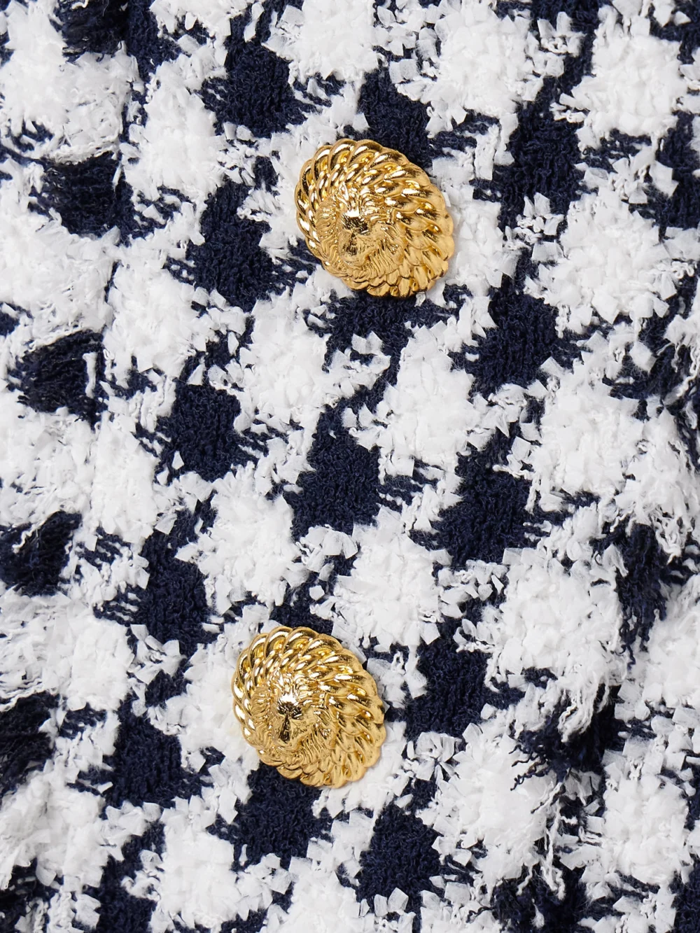 Close-up detail of the Balmain Button-embellished Frayed Tweed Mini Dress