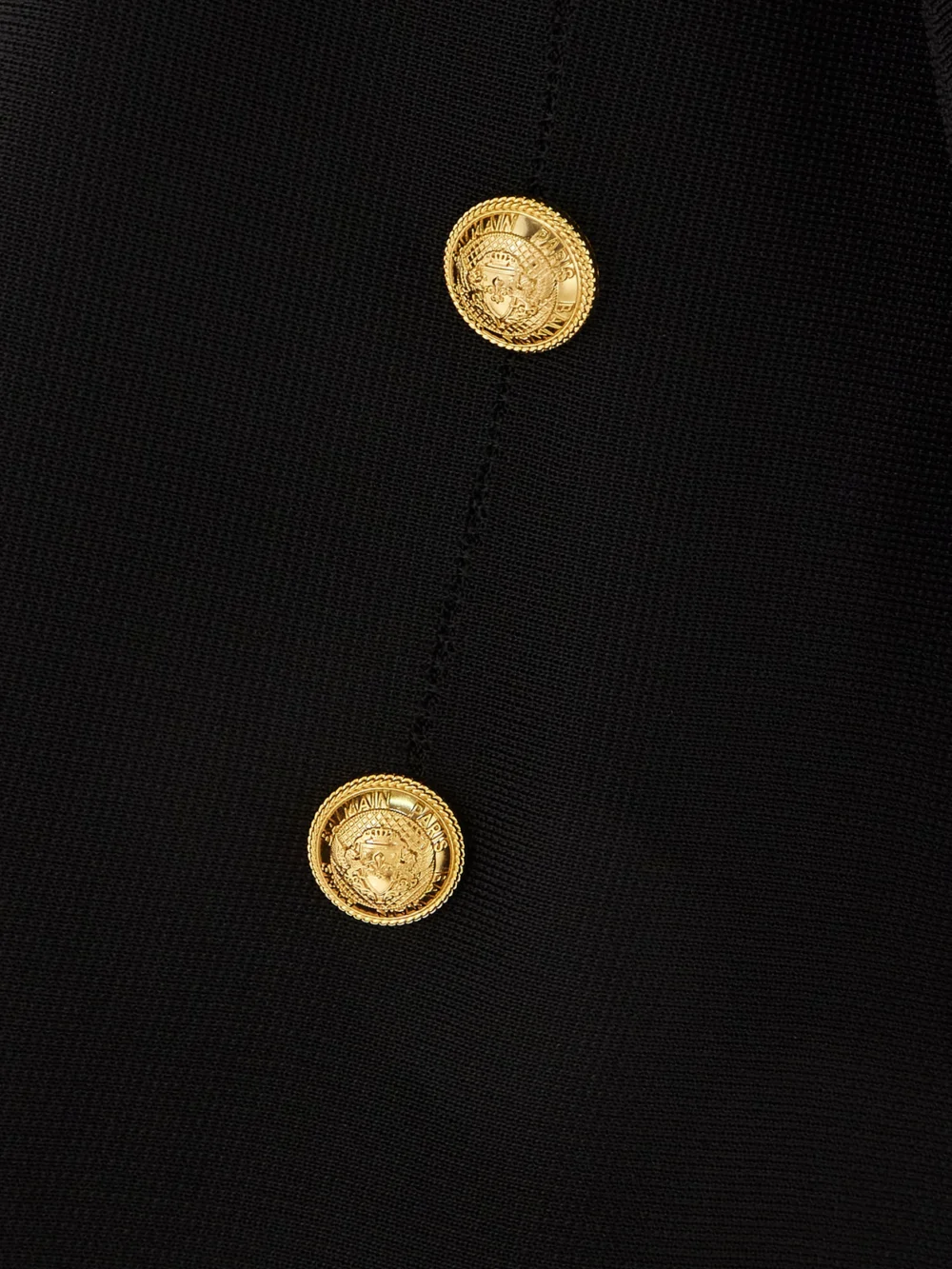 Close-up detail of the Balmain Button-embellished Knitted Halterneck Maxi Dress