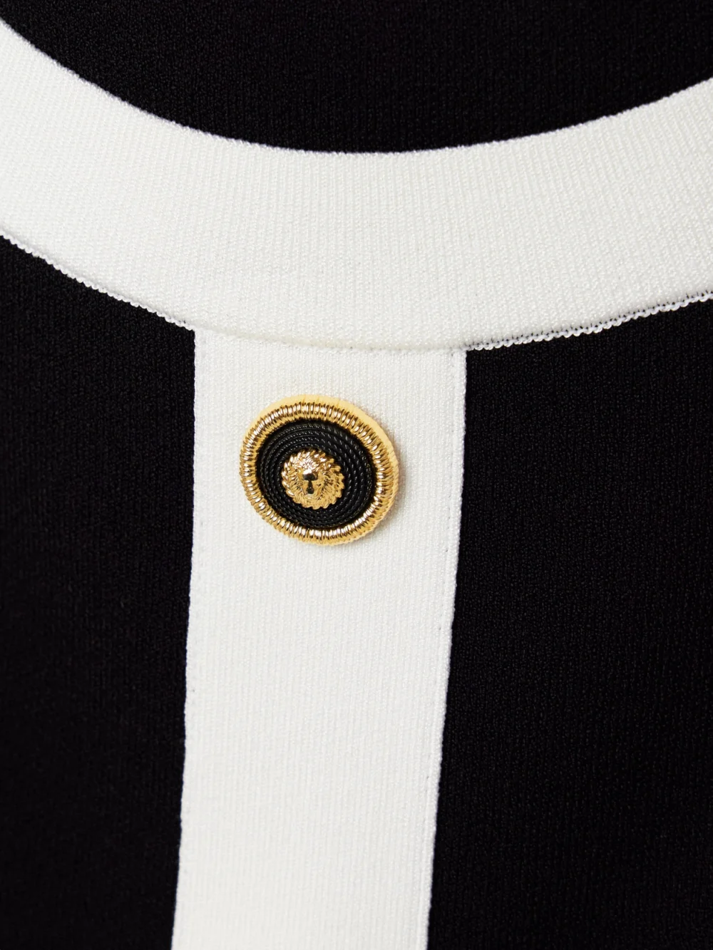 Close-up detail of the Balmain Button-embellished Knitted Halterneck Mini Dress