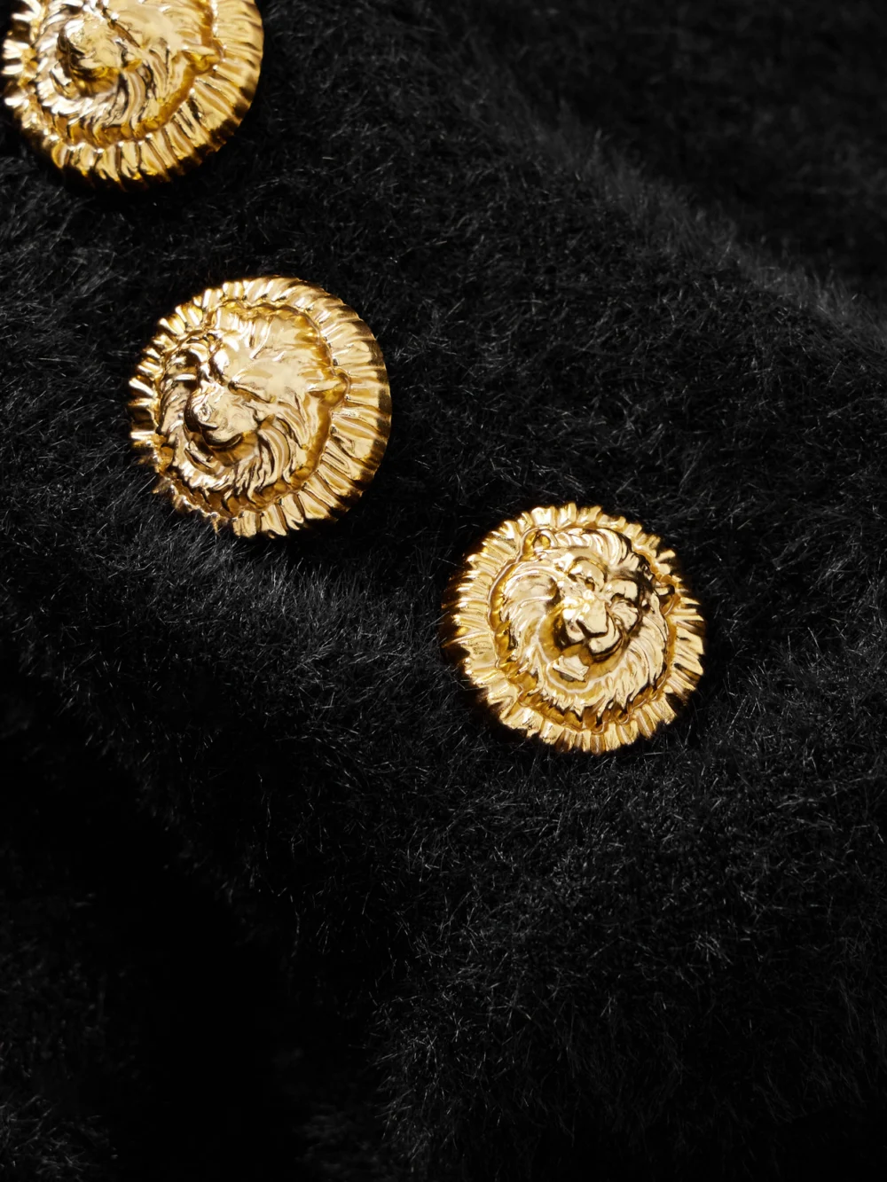 Close-up detail of the Balmain Button-embellished Open-back Brushed Knitted Midi Dress