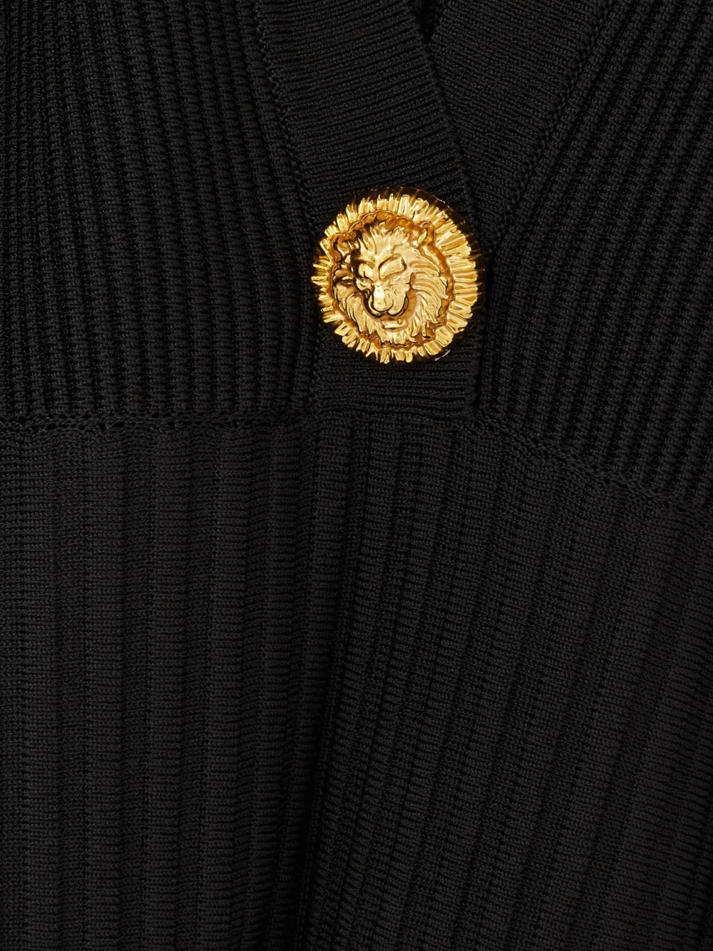 Close-up detail of the Balmain Button-embellished Ribbed Knit Mini Dress